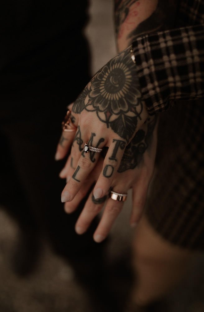 Detailed ring shot of two brings with tattoos