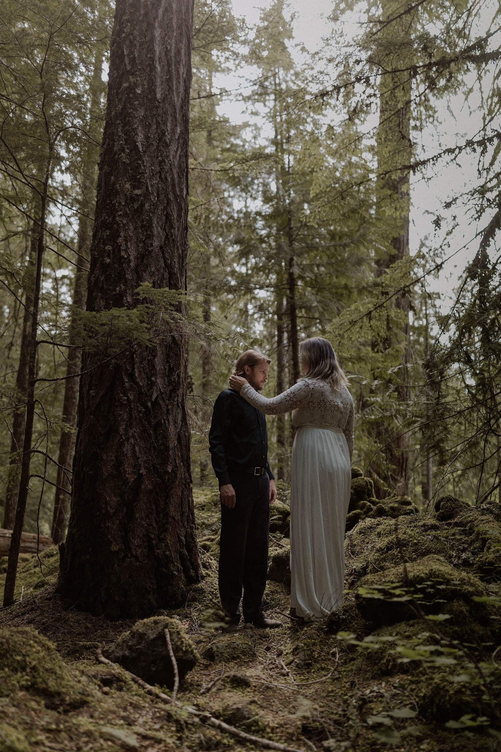 Couple hiking in the forest for their wedding