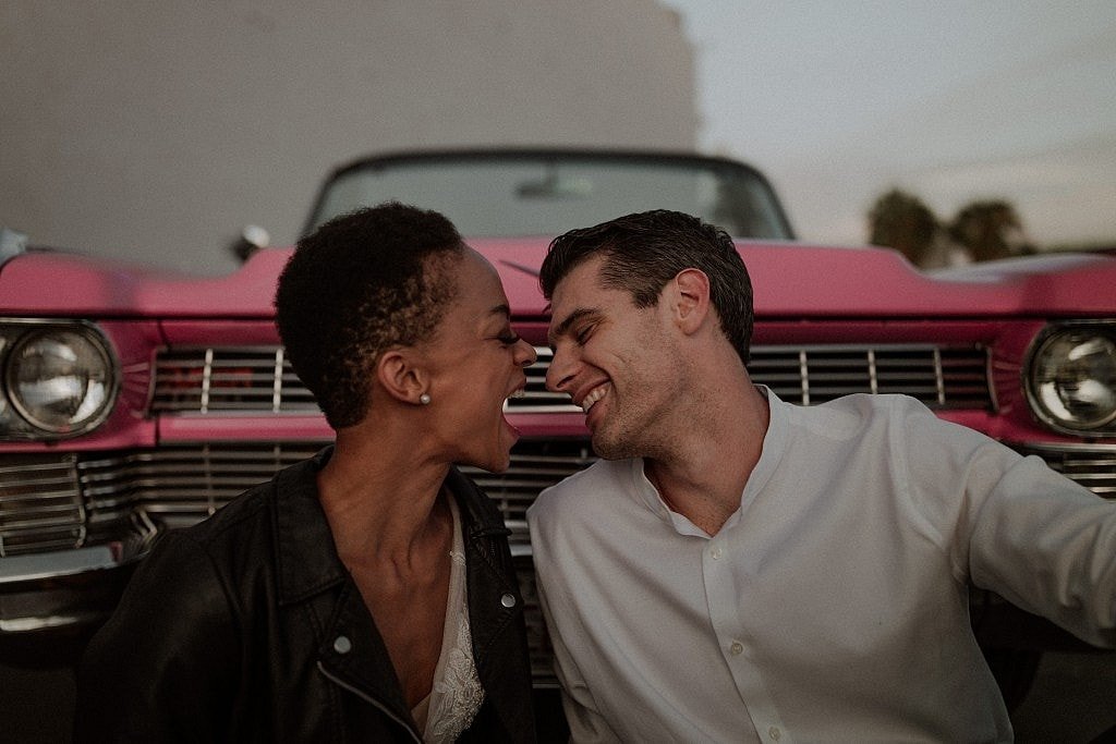 Downtown Las Vegas Sunset elopement with pink caddy mixed couple leather jacket