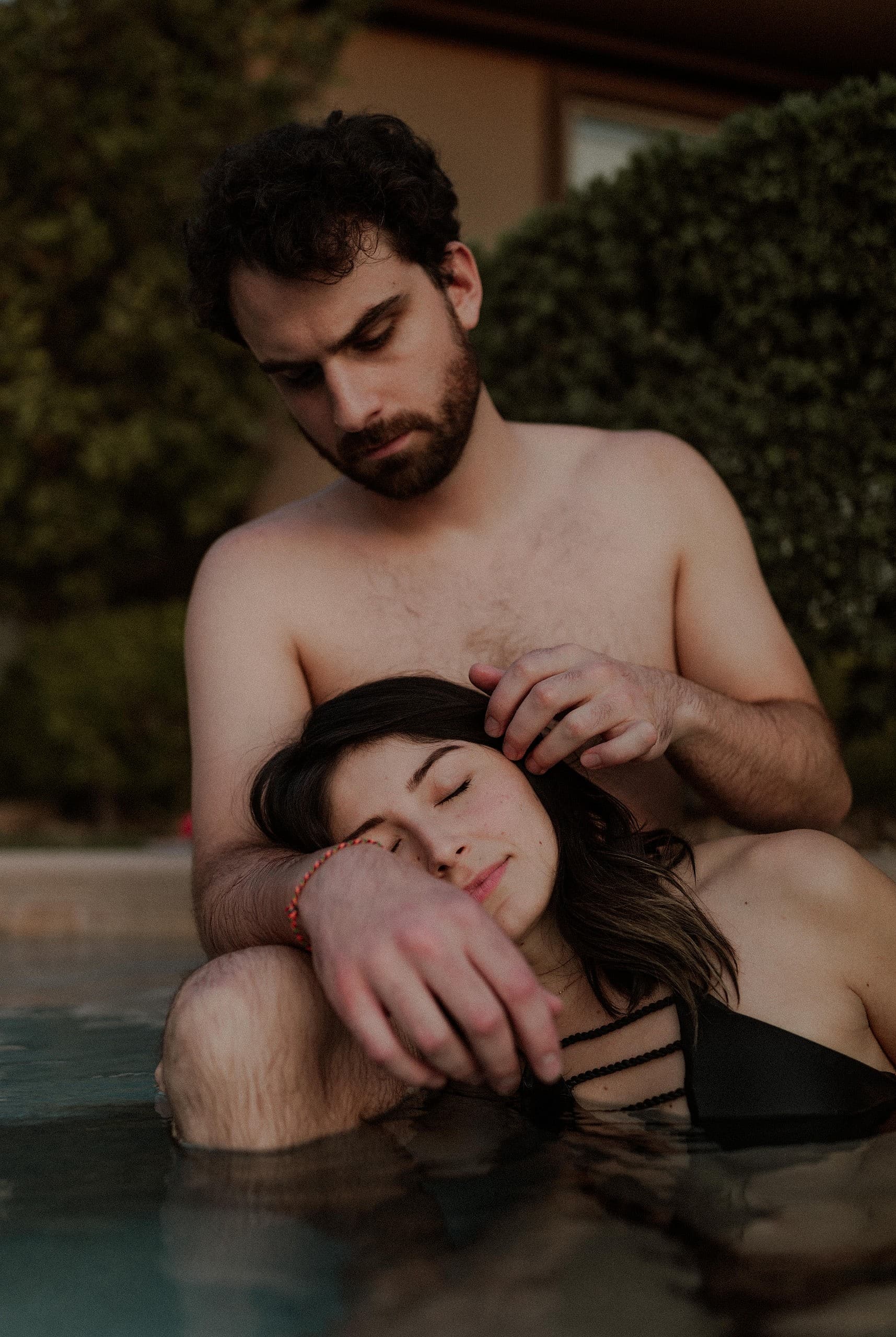 Moody romantic couples photos in pool by Las Vegas Elopement Photographer