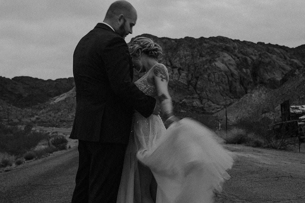 Wedding couple dance in the middle of the road at El Dorado Ghost Town Elopement in Las Vegas