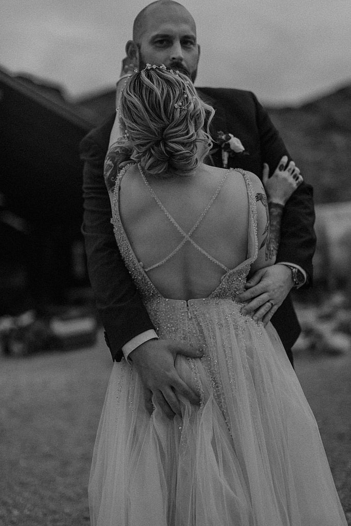 Groom grabs brides butt in a playful image for wedding