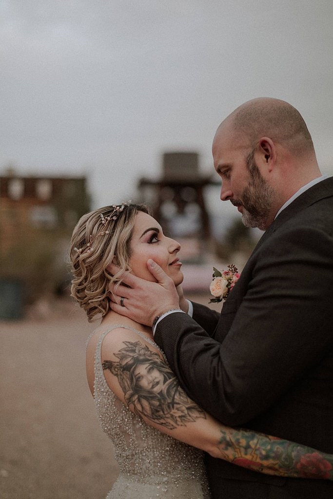 Groom holds brides face intimately during elopement