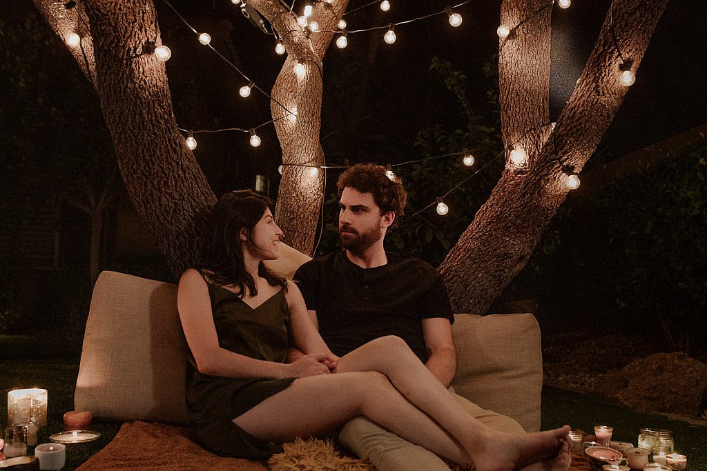 In-home engagement session in Las Vegas with cozy blankets and candles