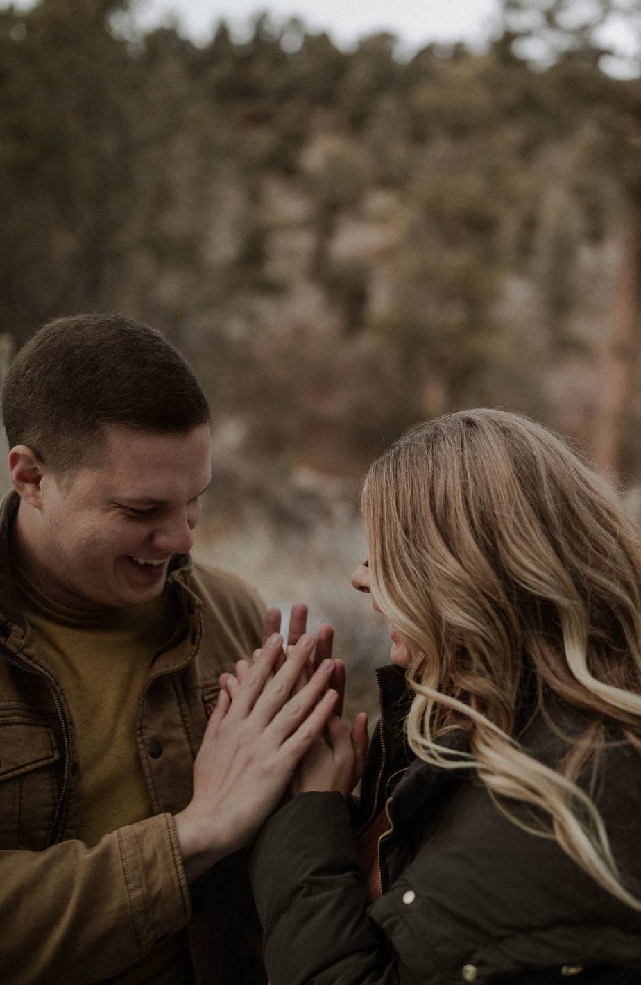 Couple tries to warm each other's hands during their Oregon Adventure Engagement session