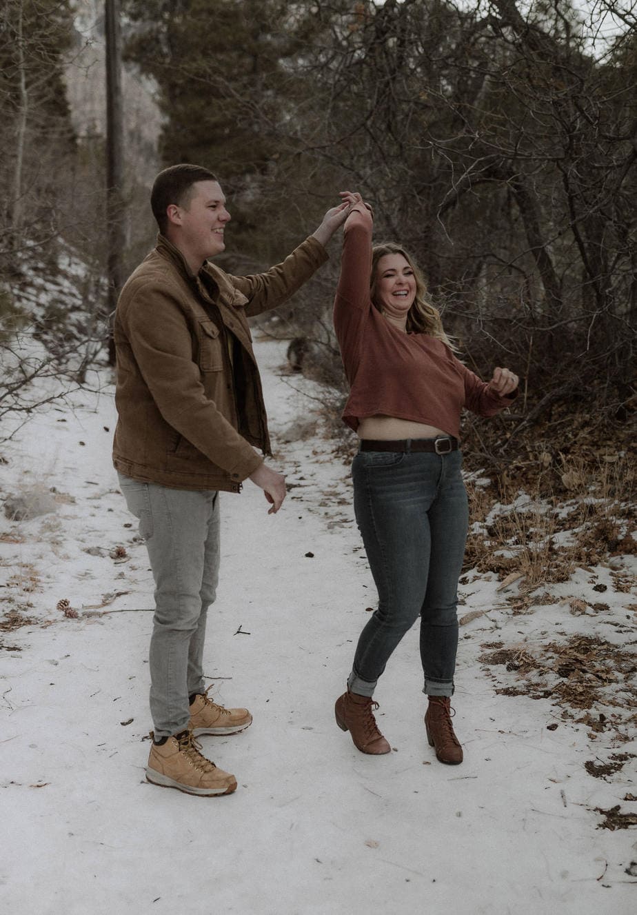 Playful engagement session in the mountains with snow everywhere. Winter engagement sessions don't have to be boring!