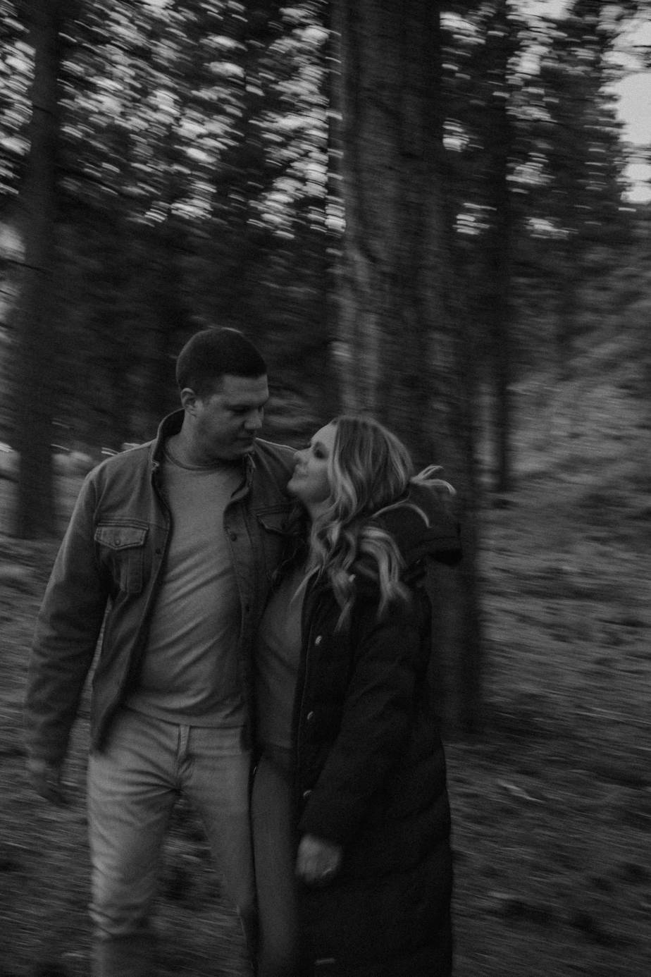 Artsy black and white image of engaged couple during their Oregon adventure engagement session on the mountains. Blurry image to showcase the movement