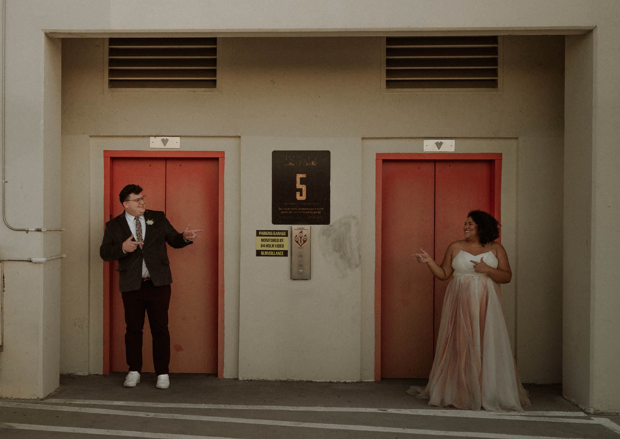 Portland Oregon elopement on top of a parking garage with red elevator. Mixed race couple LGBTQ friendly photographer Portland