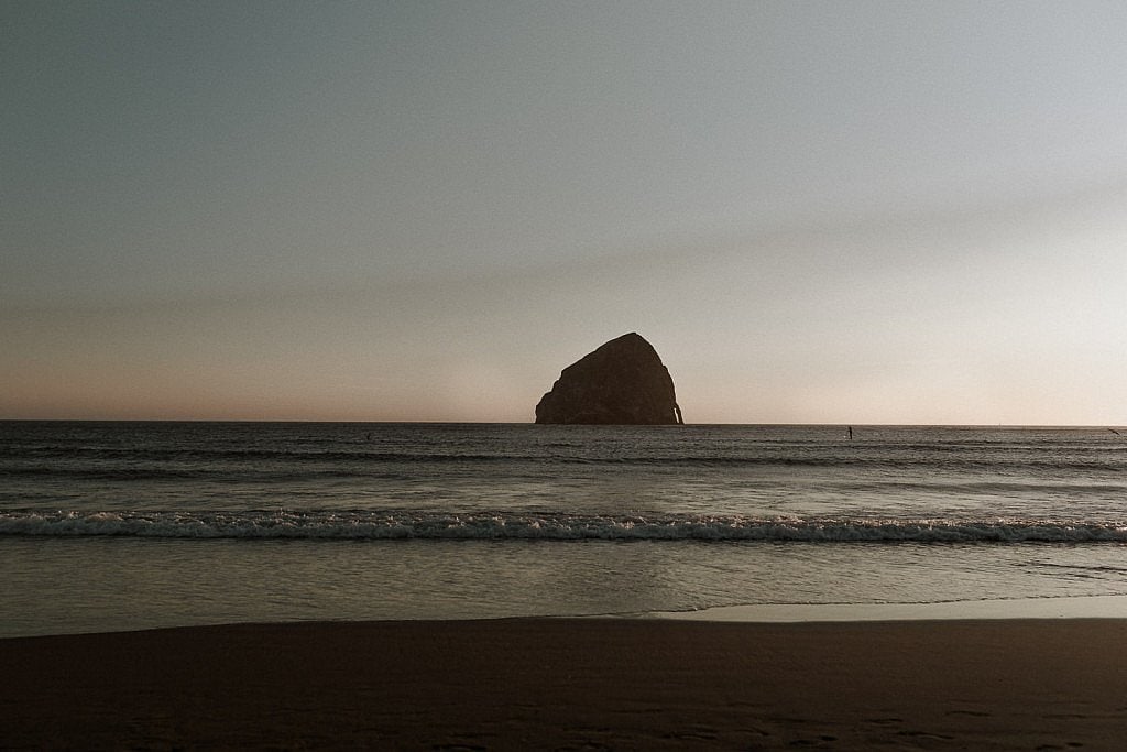 Empty beach image of the sunset at blue hour at Cape Kiwanda in Pacific City, Oregon. This beach is a great spot for your romantic coastal beach elopement