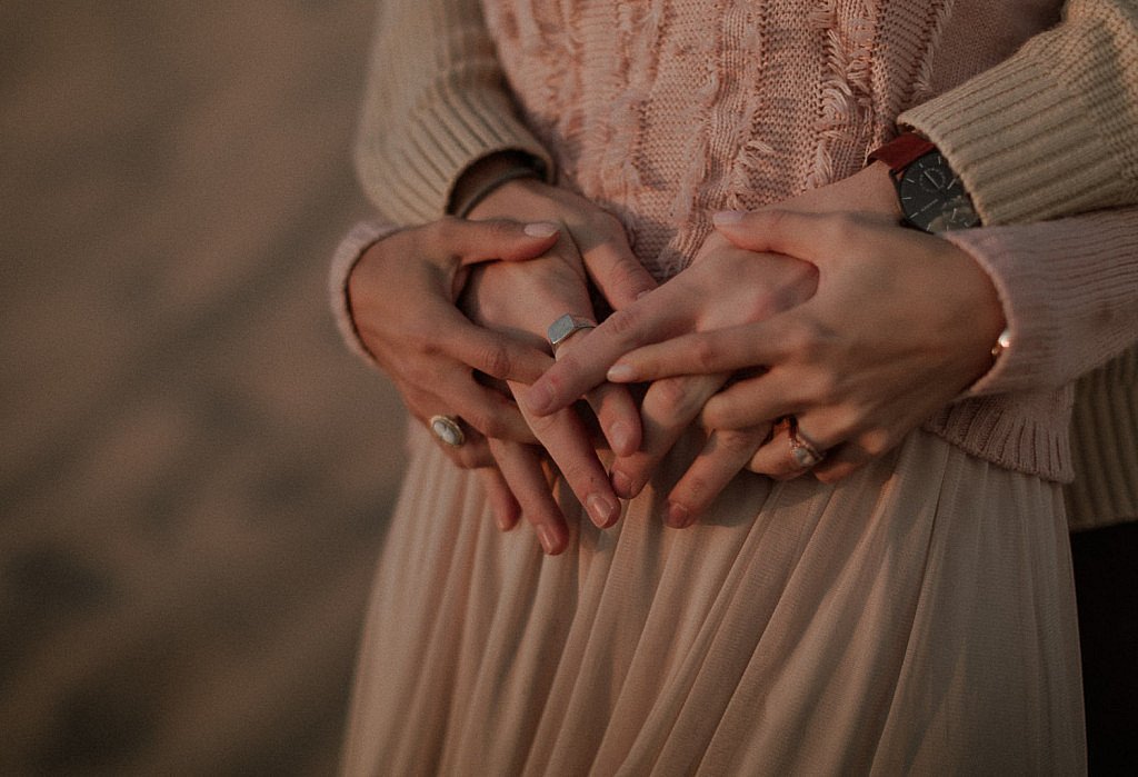 Close up image of couples hands as they caress each other