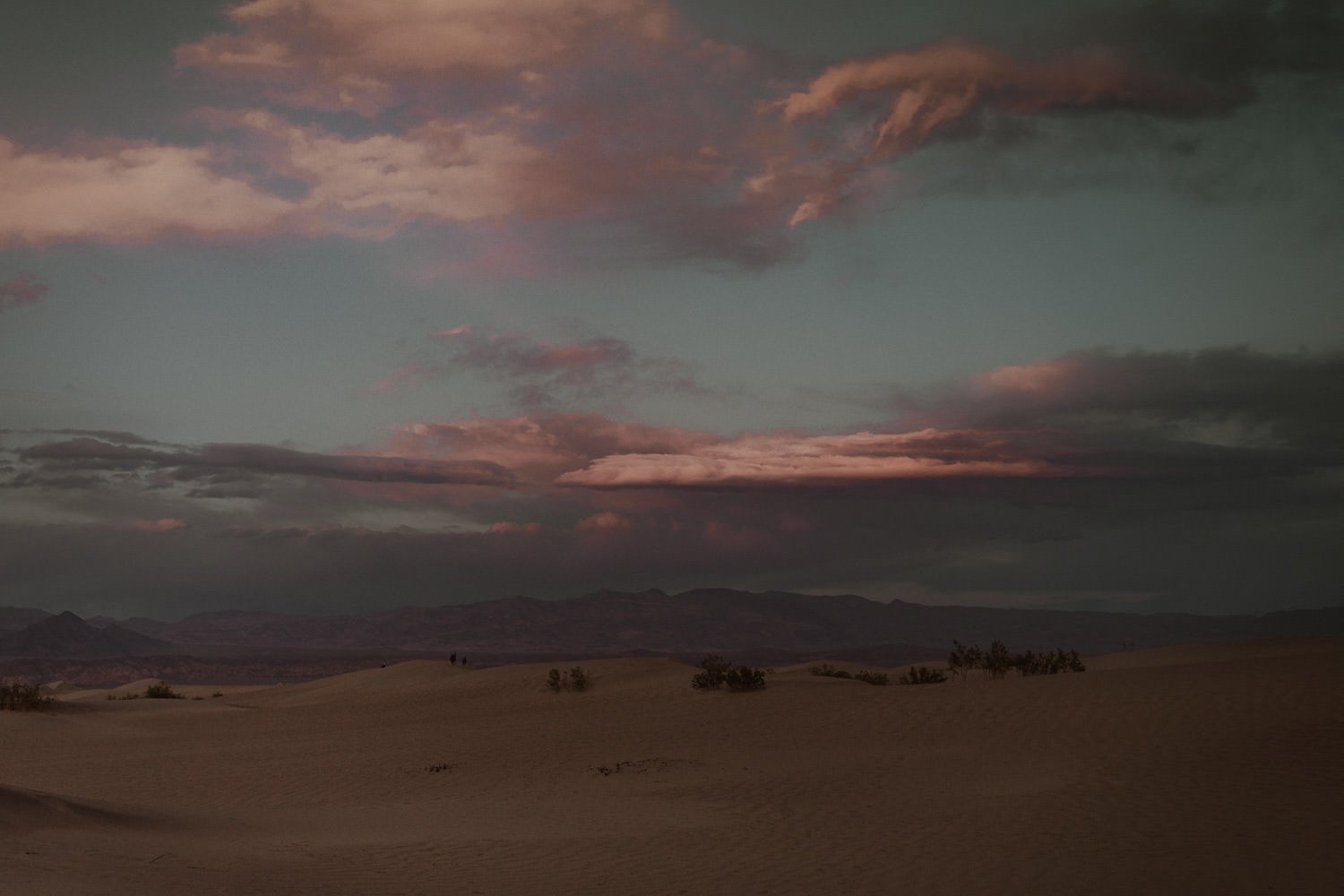 Amazing desert sunset with pink clouds, blue skies, and purple mountains was the best ending to an intimate elopement