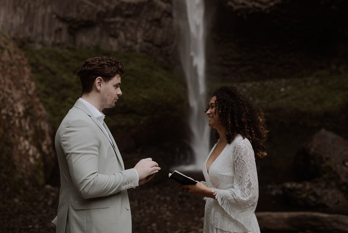 Intimate elopement under a waterfall at Latourell Falls in Oregon. This waterfall right outside of Portland in the Gorge is the perfect place for an adventure elopement ceremony. Its just a short hike down to the falls and has breathtaking views.