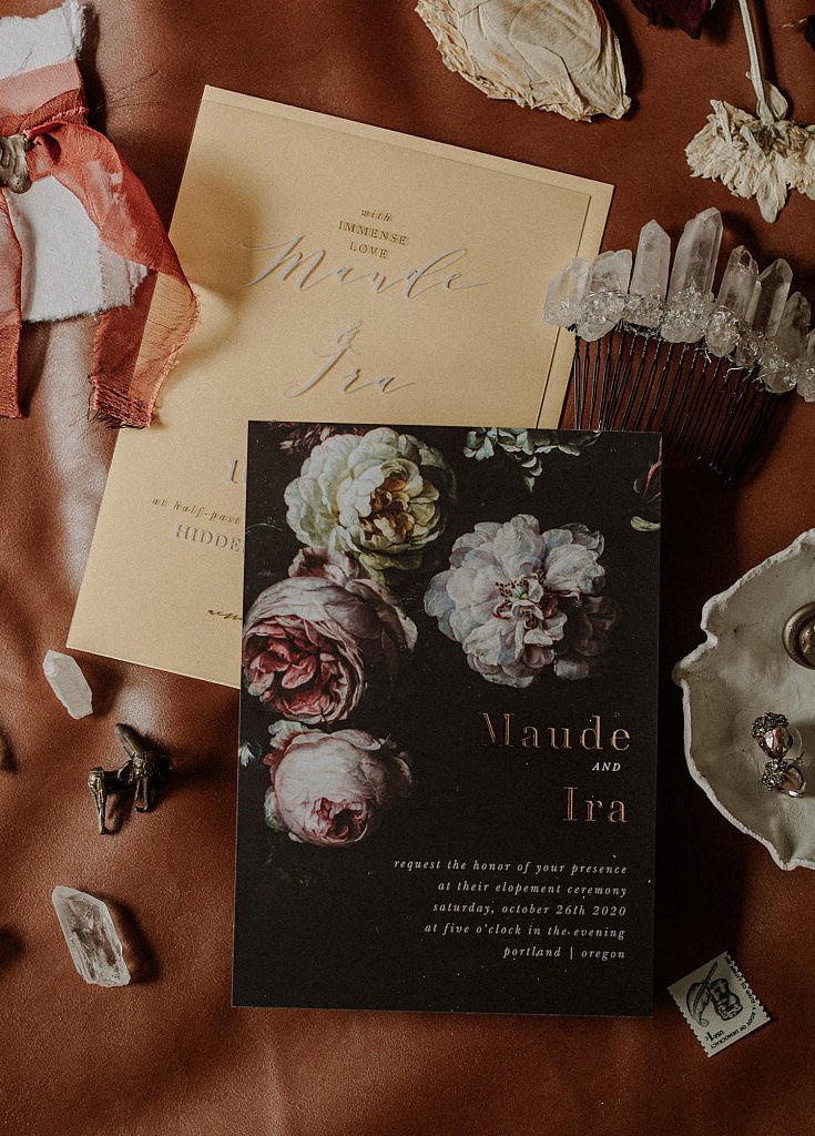 Moody flatlay for the wedding invitation suite for an eloping couple in Oregon