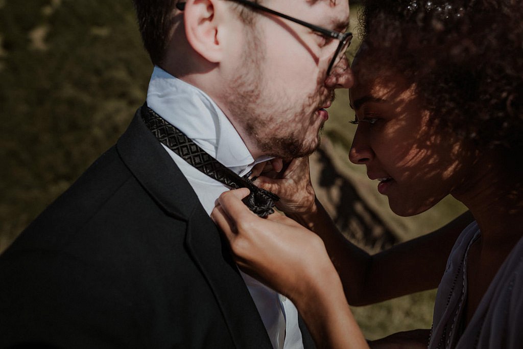 Bride fixes the groom's bowtie at their adventure elopement on God's Thumb.