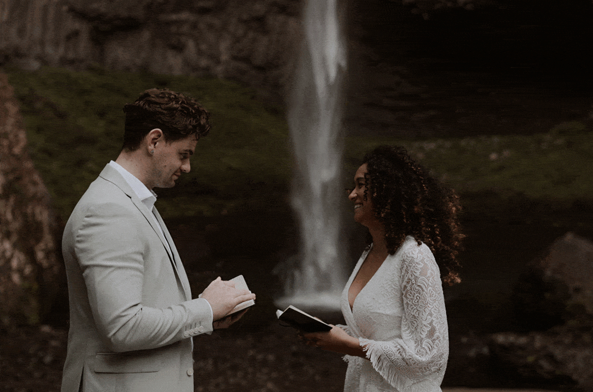 Latourell Falls Elopement in Columbia River Gorge, Oregon. Bride and groom say their vows next to the tall waterfall