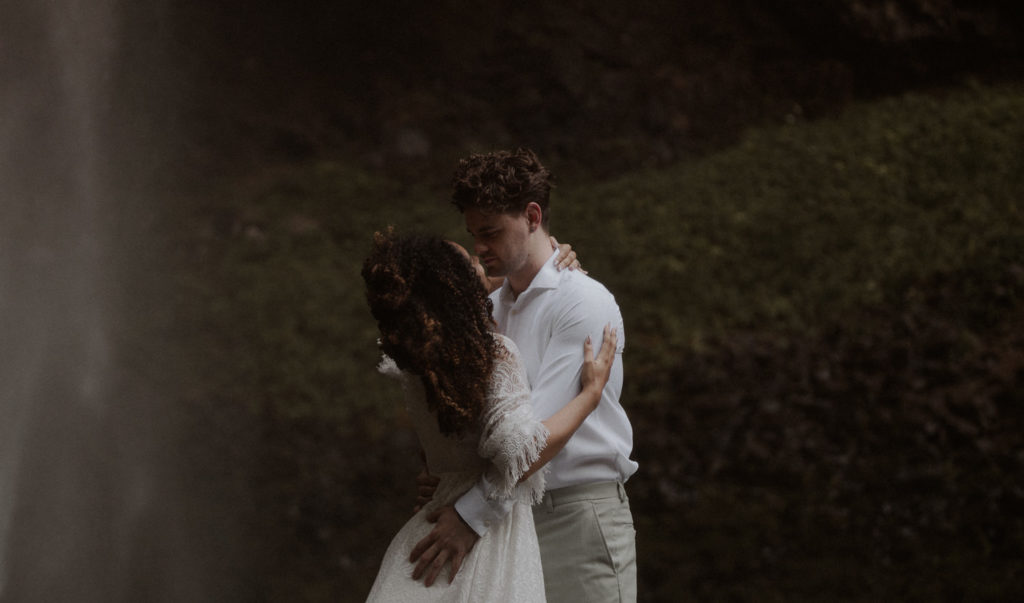 Latourell falls elopement couple embraces under the waterfall