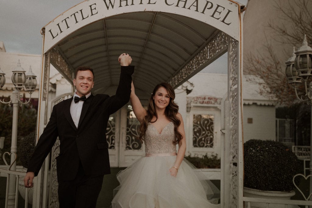 Little White Wedding chapel elopement, bride and groom throw up their hands in congratulations