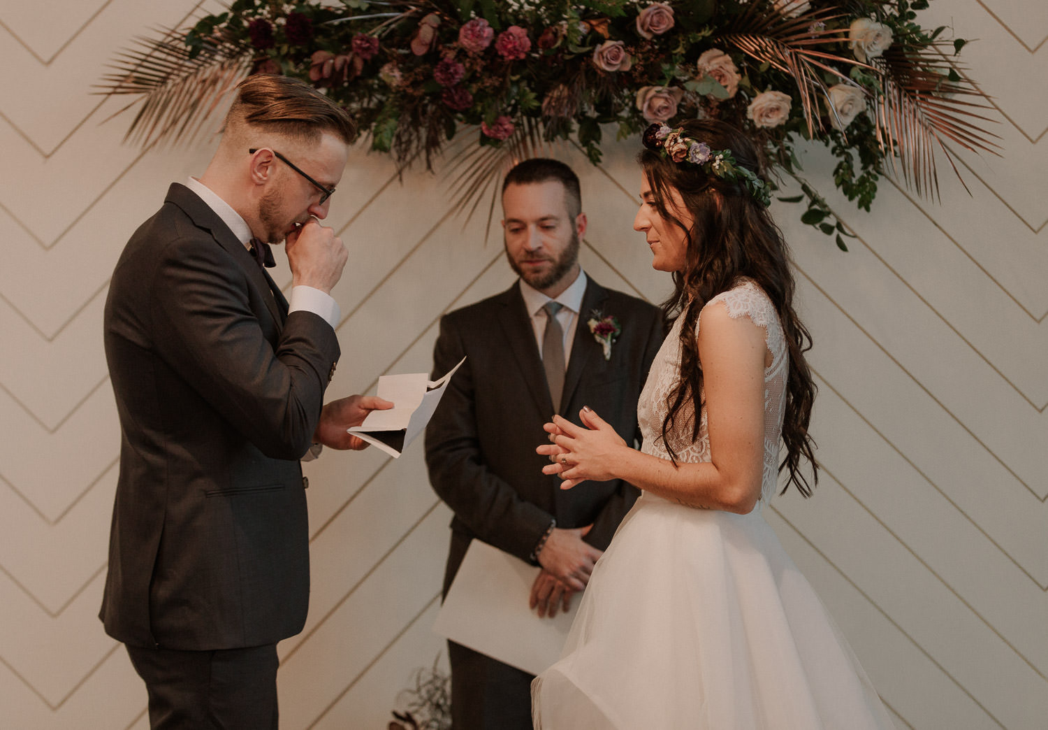 Writing your own vows for your elopement can be hard. Bride and groom share their vows during the ceremony. Groom holds back tears as he reads his vows