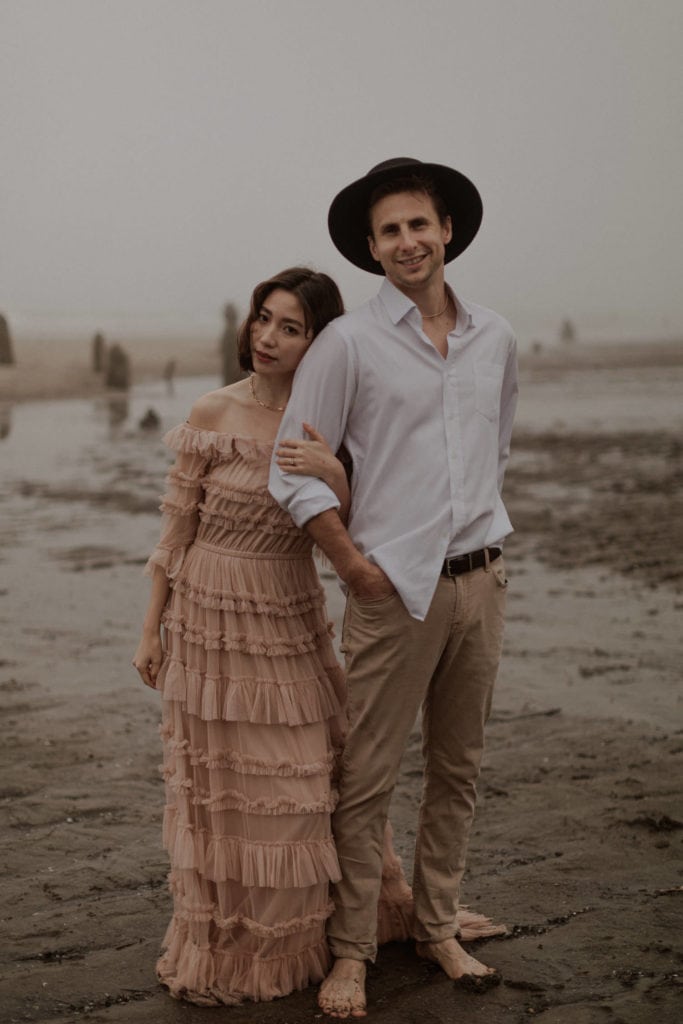 Eloping couple stands in the beach