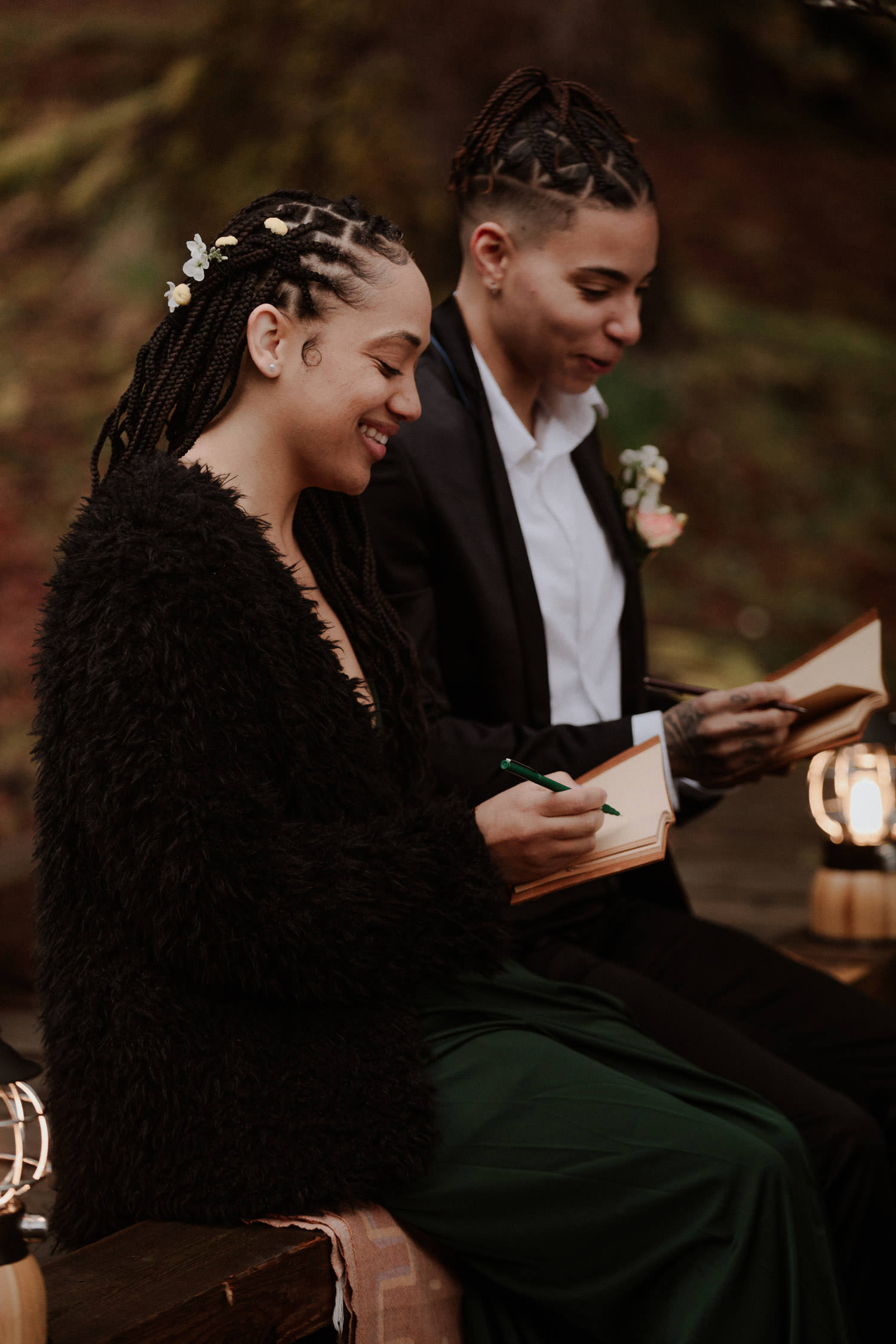 Couple writes their vows together by lamplight before their elopement ceremony
