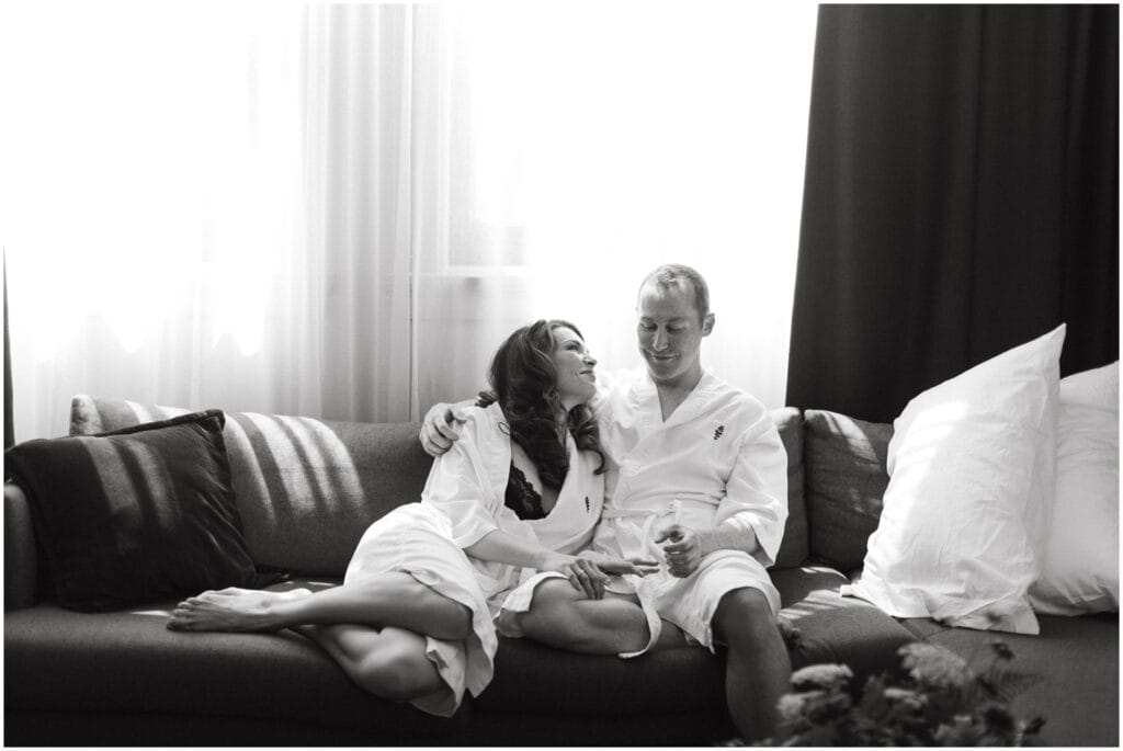 Couple wears matching robes while getting ready for their wedding day in downtown Portland hotel room
