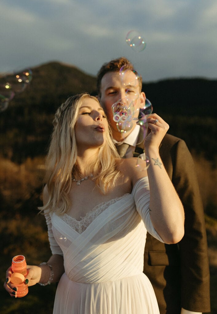 couple blowing bubbles at Government Cove for their Oregon elopement