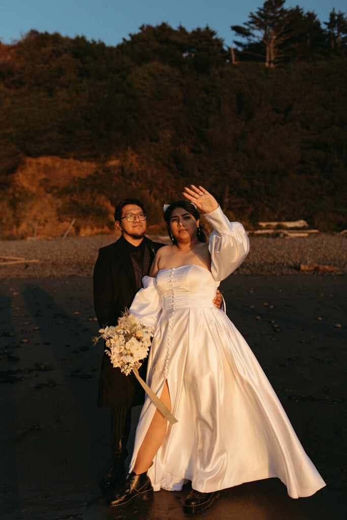 bride and groom looking out into the sunset on the Oregon coast