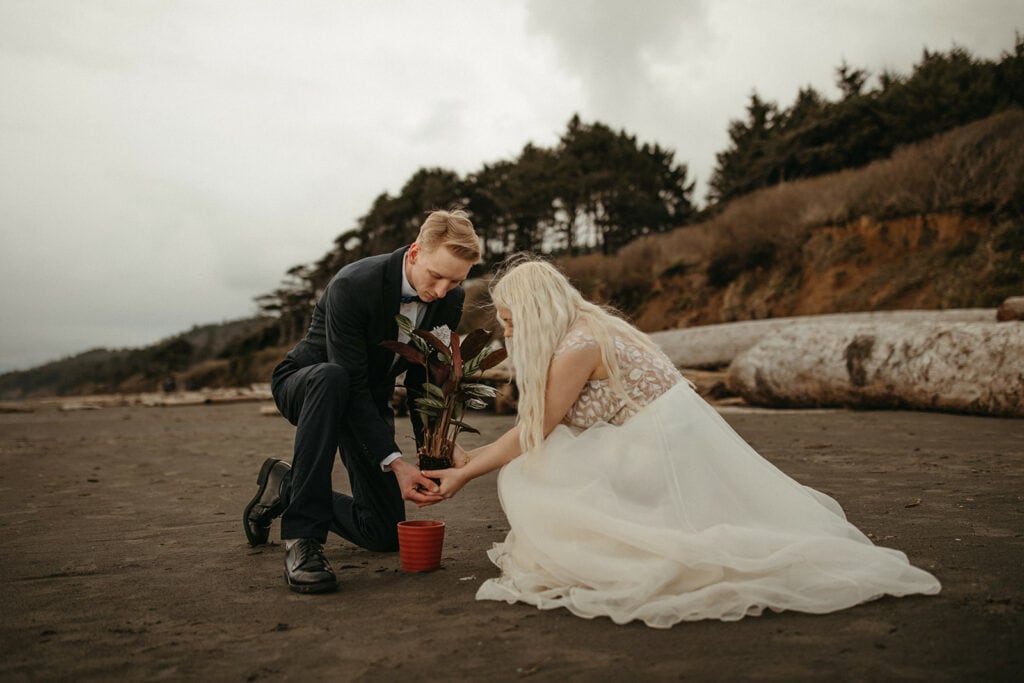 bride and groom planting pot as part of their elopement unity ceremony at Kalaloch Beach