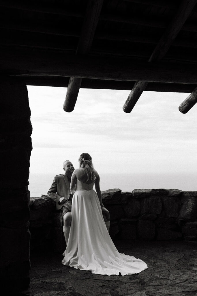 bride and groom photos in stone shelter on the Oregon Coast