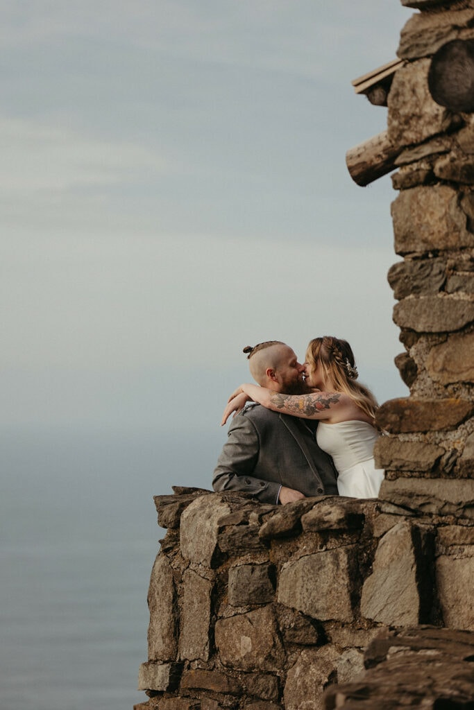 bride and groom photos in stone shelter on the Oregon Coast