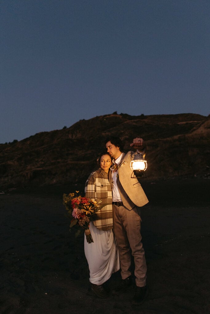 bride and groom night time groom holding lantern 