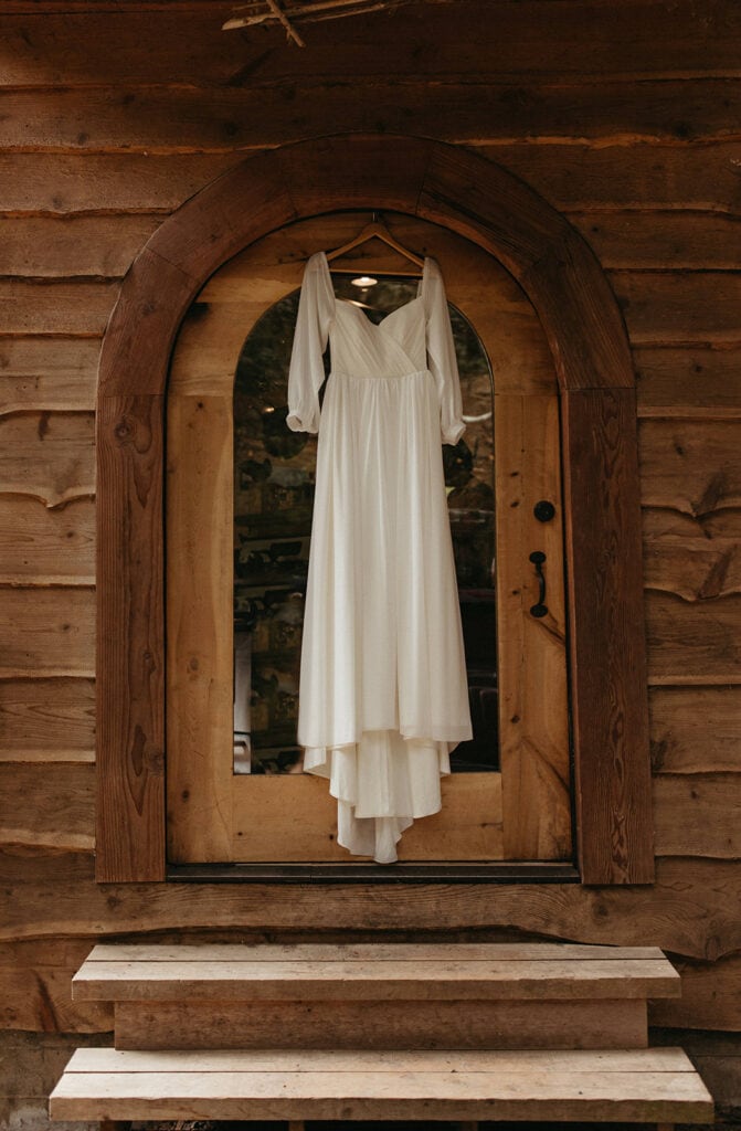 bridal gown hanging above the door at airbnb 
