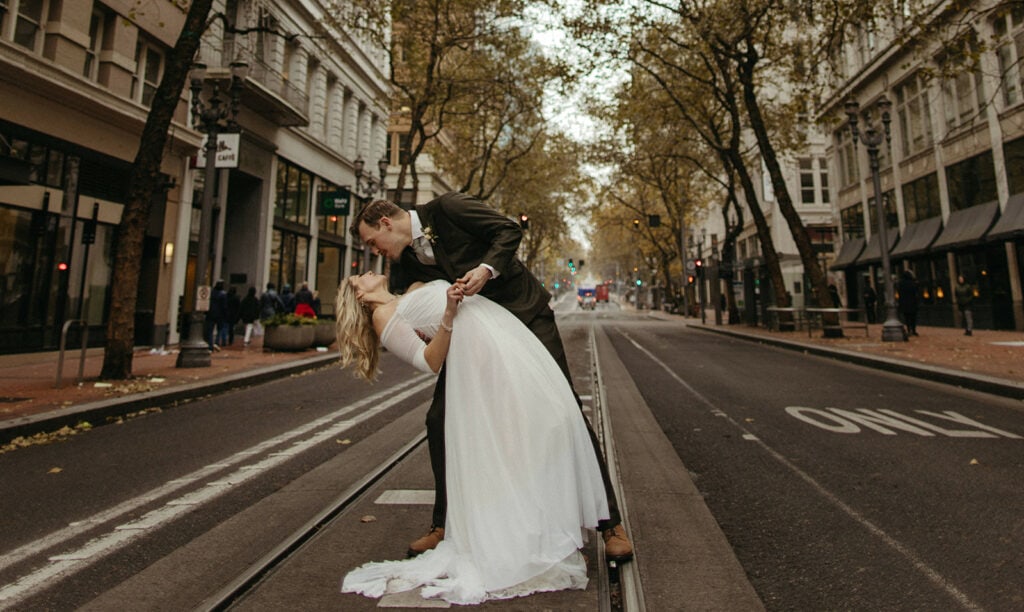 couple on railroad tracks in the street of Portland