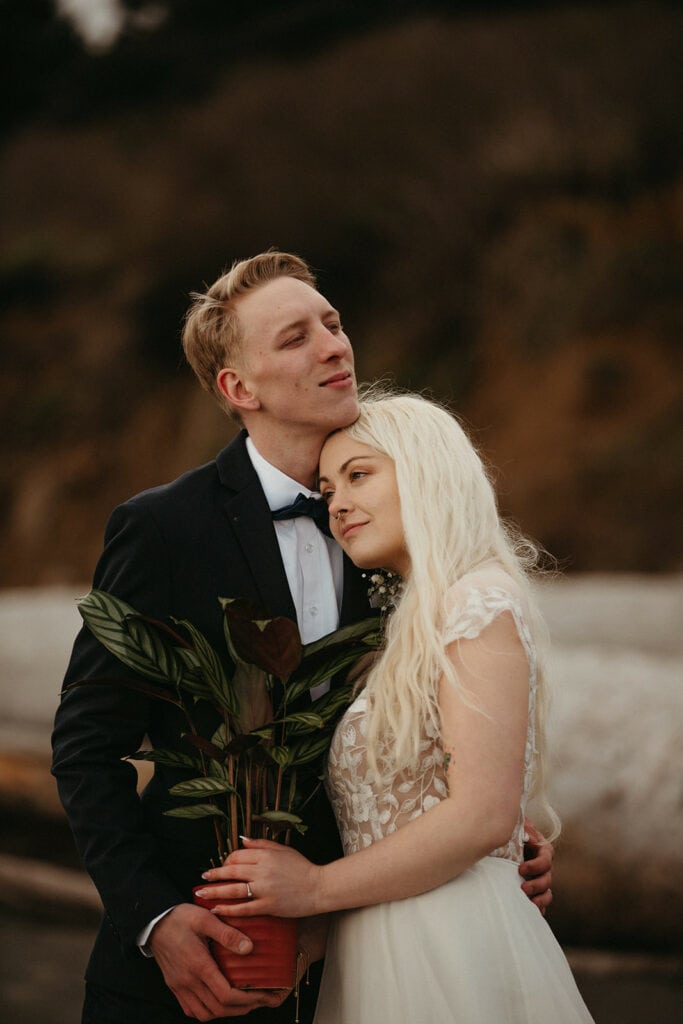 bride and groom holding their potted plant for their unity ceremony 