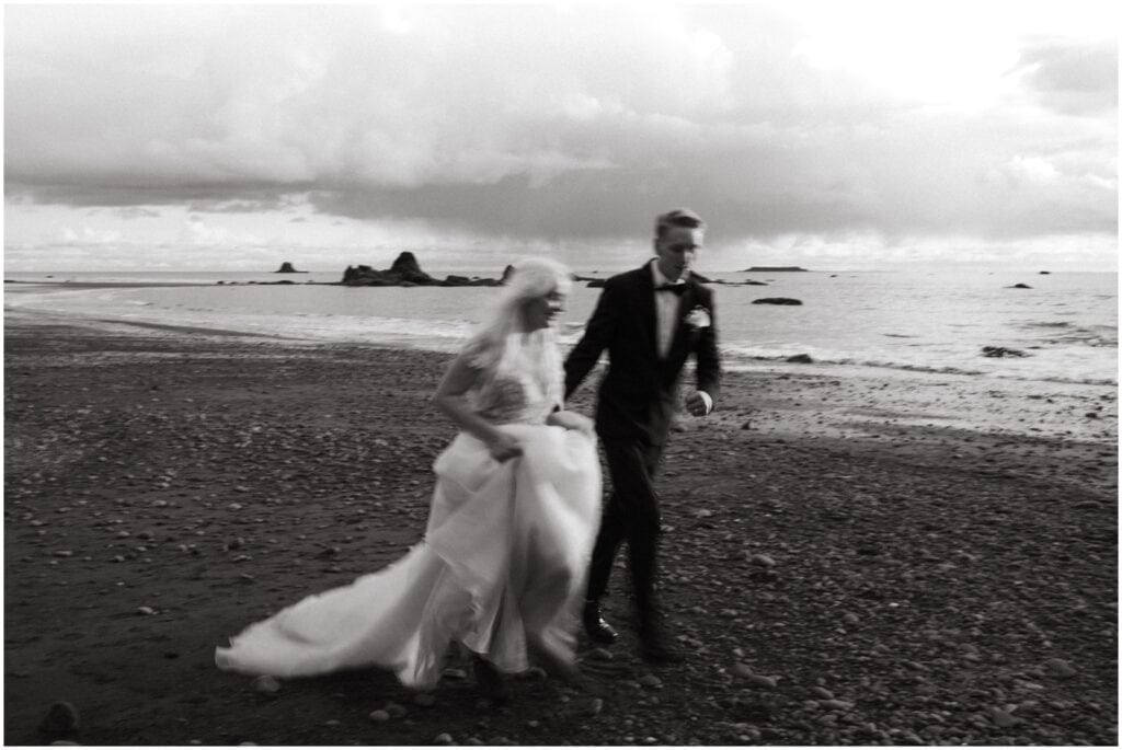 black and white photo of bride and groom blurry beach shot at ruby beach in Washington state
