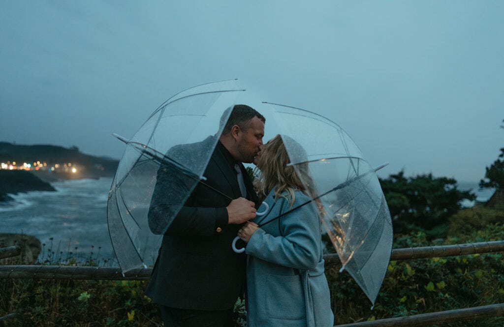 Clear umbrellas add charm to Katie and Chris's elopement portraits captured in the on-and-off rain.