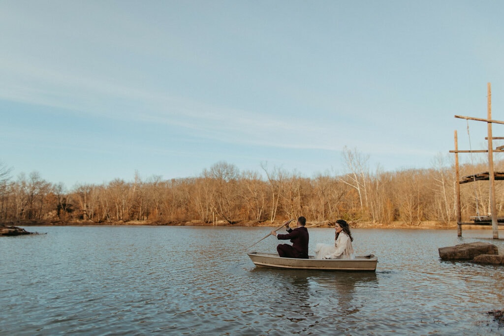 couple paddling around the pond in a small metal boat