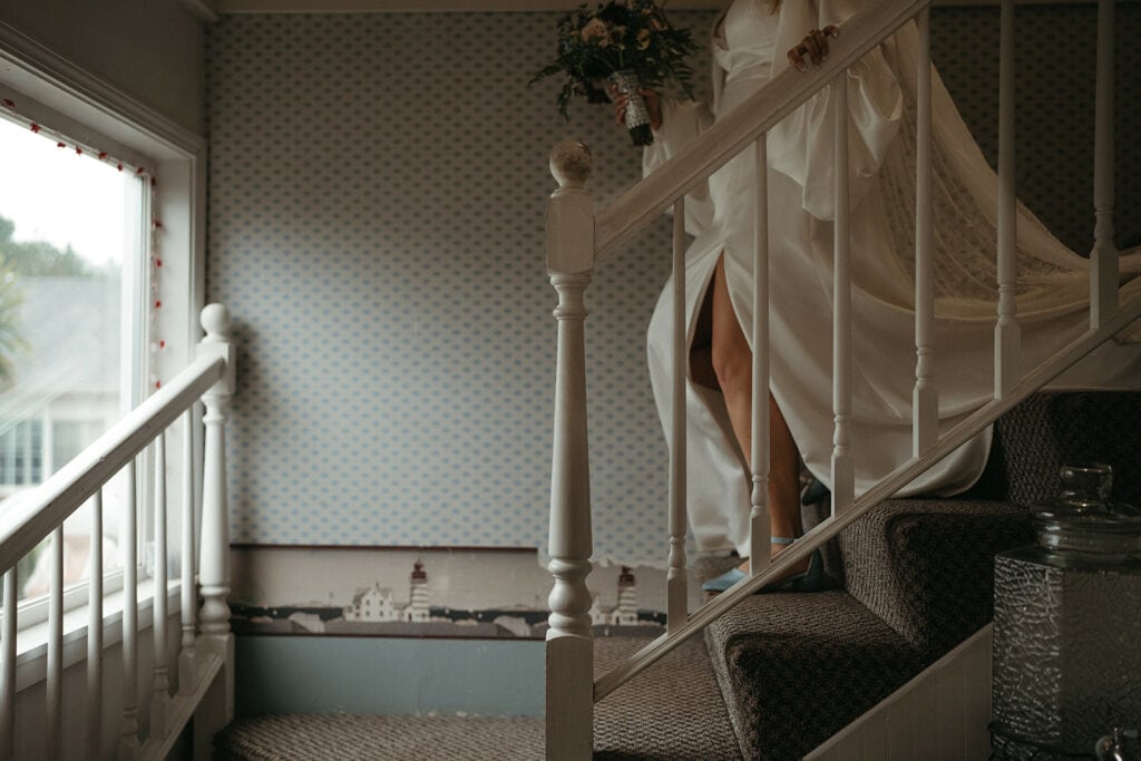 Katie walking down the stairs at the Inn, heading out to elopement ceremony