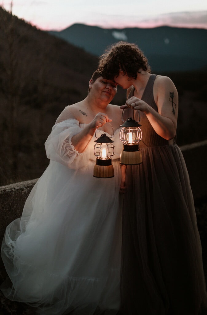 couple holding lanterns for their winter elopement at Mt. Hood 