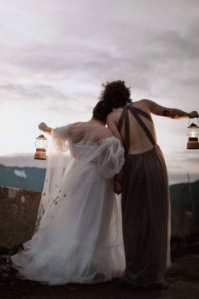 couple holding lanterns for their winter elopement at Mt. Hood 