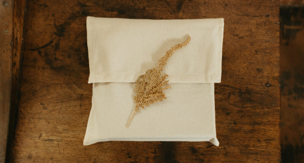 A wedding album packaged in an eco-friendly cloth packaging by an Oregon elopement photographer