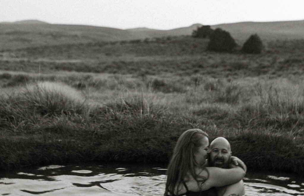 A couple enjoys a hot spring for their engagement photoshoot