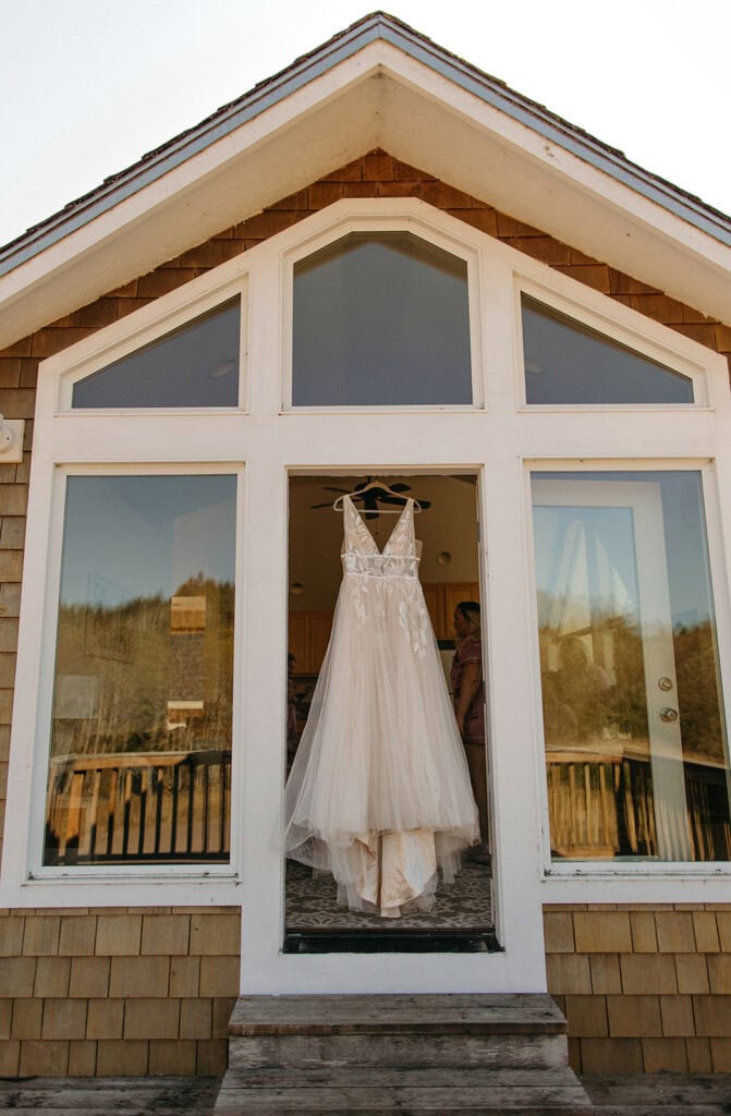 Bride's dress hanging in the doorway