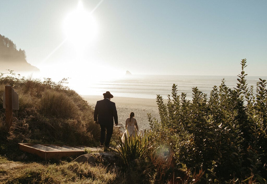 Bride and groom walking down to their Oregon Coast elopement ceremony location