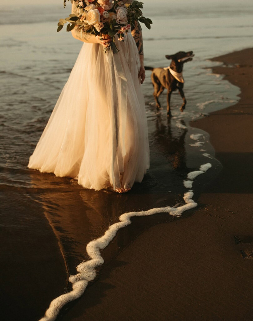Bride runs with her dog down Cape Meares Beach